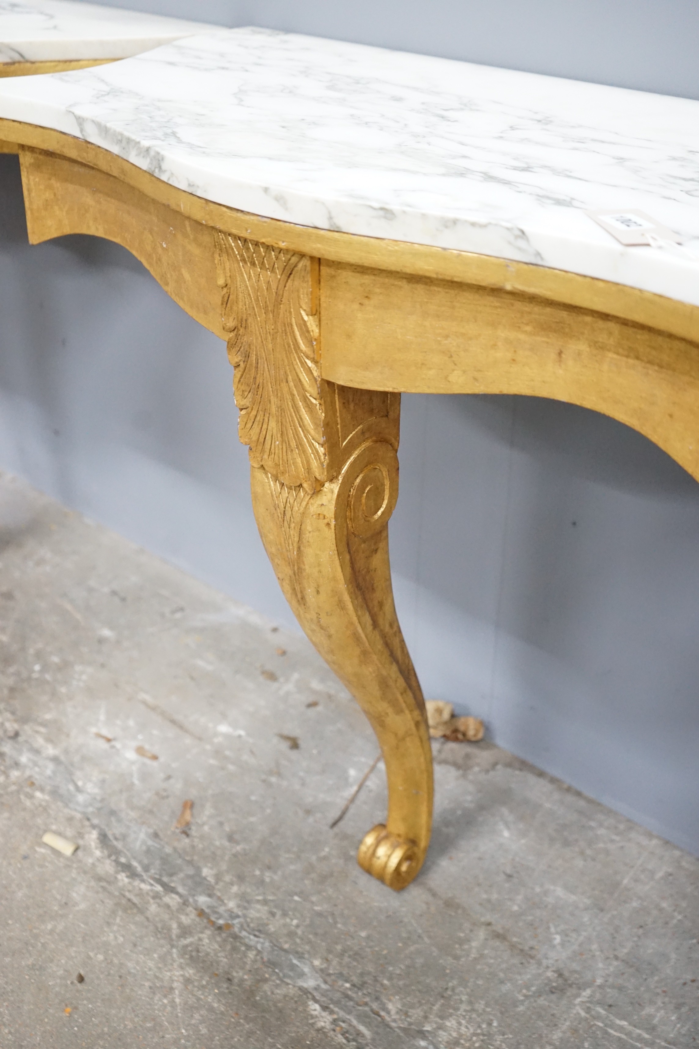 A pair of Victorian style marble topped serpentine giltwood console tables, width 84cm, depth 44cm, height 79cm